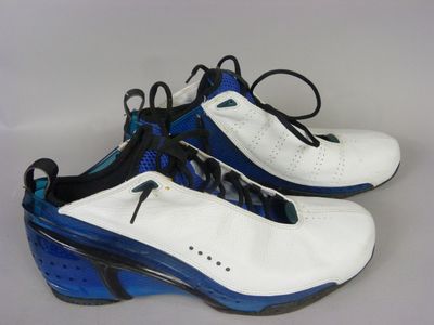 pair of white and blue shoes with black laces on them