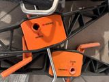 two orange hooks attached to the back of a bicycle