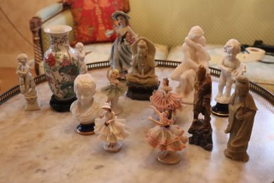 many figurines sitting on a table in a living room
