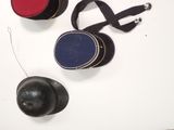 three hats and a ball on a white surface