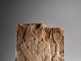 a close up of a stone block with a man and a woman on it