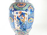 a blue and white vase with a lid on a white background