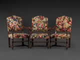 a set of three carved and upholstered armchairs