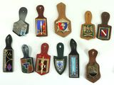 a lot of different types of badges on a white surface