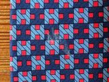 a blue tie with red and blue squares on it