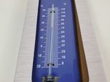 a large blue thermometer sitting on top of a cardboard box