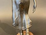 an image of a statue of a woman holding a flower in her hand