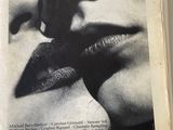 an image of a magazine with a picture of a man kissing a woman ' s lips