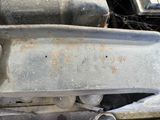 a close up of a car ' s front bumper and engine