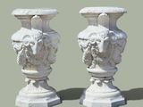 two white vases with faces on them on a green background