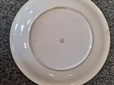 a white plate on the floor next to a white plate on the floor