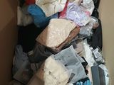 a cardboard box full of clothes and other items in it