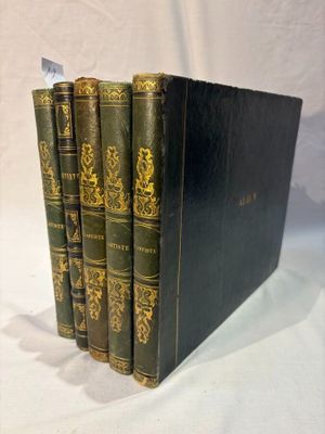 three books are stacked on top of each other on a white surface