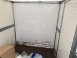 a small room with a toilet and a box in it