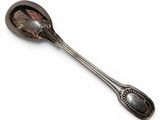 an antique spoon with a spoon handle on a white surface