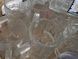 a box of empty beer glasses and a bottle of water
