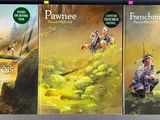 three books are sitting on a table in front of a wall
