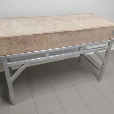 un banc en bois avec des pieds en métal dans une pièce