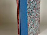 the book is sitting on a white surface with a blue cover