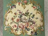 a green rug with a floral design on it