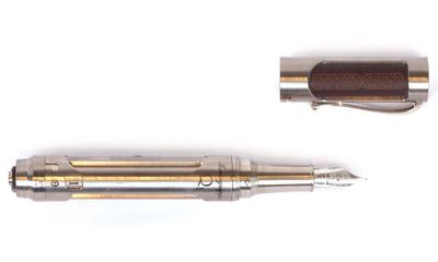 two pens that are sitting next to each other on a white surface