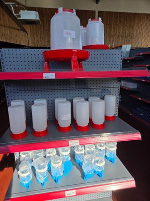 a shelf with several bottles of water on it in a store
