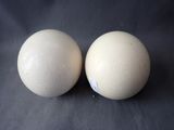 pair of two eggs sitting on top of a black surface