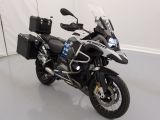 une moto noire et argentée garée dans une pièce blanche