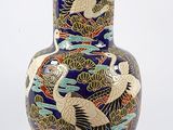 a vase with a dragon design on it on a white background