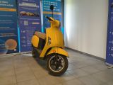 a yellow scooter that is parked in a room