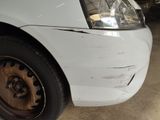 a close up of a car ' s front bumper with a denting on it