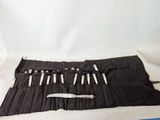 a roll - up knife holder with a knife in it