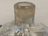 a glass vase that has a blue design on it