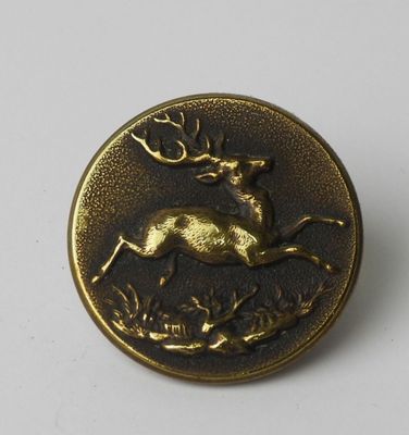 an image of a bronze button with a deer on it