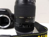 a camera with a lens attached to it ' s strap