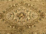 beige area rug with a floral design on top of it