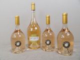 four bottles of wine are lined up on a table