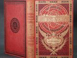 a red book with gold lettering on it sitting on a table