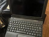 a laptop computer sitting on top of a bag on the floor