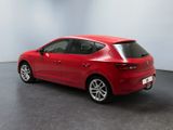 the rear end of a red car in a white room
