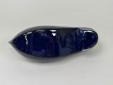 a close up of a blue glass object on a white surface