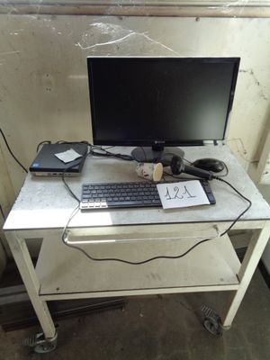 a computer desk with a keyboard and a monitor on it