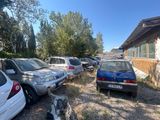 many cars parked in a parking lot next to a building