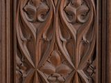 carved wood door with a floral design in the middle