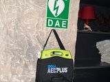 a bag hanging on a wall next to a fire extinguisor