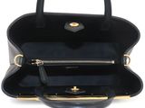 a black leather handbag with a gold handle