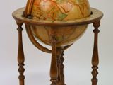 a wooden stand with a globe on it on a white background