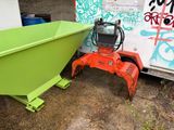 a green dumpster sitting next to a yellow dumpster