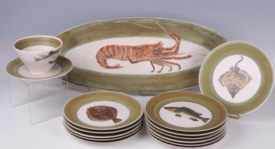 many plates and cups on the table with a picture of a lobster on them