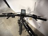 a close up of a bicycle with a digital display on the handlebars